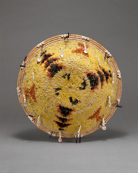 Fully feathered three-rod coiled plate-form basket, Pomo artist (Lake County, California), Willow shoot foundation, sedge root weft, feathers (red-winged blackbird, western meadowlark, mallard, California valley quail topknots), clamshell disk beads, abalone pendants, and cotton string, Pomo (Lake County, California) 