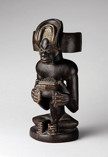 Commemorative figure of a chief playing a sanza (thumb piano), Wood, kaolin, Chokwe peoples 