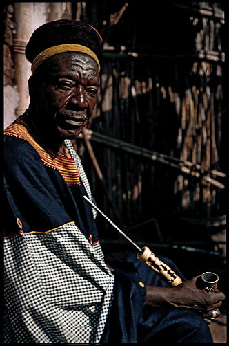 Portrait of Fon Nsom (r. 1966–75) holding a prestige pipe in brass and ivory