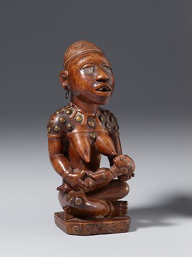 Figure: Seated Female Nursing Child