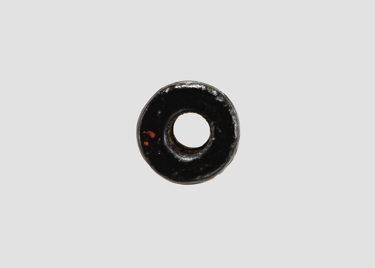 Cylinder seal and modern impression: seated figure holding the tail of a griffin, Black steatite, Cypriot