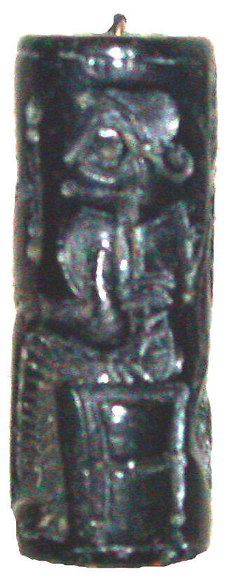 Cylinder seal and modern impression: seated figure holding the tail of a griffin, Black steatite, Cypriot