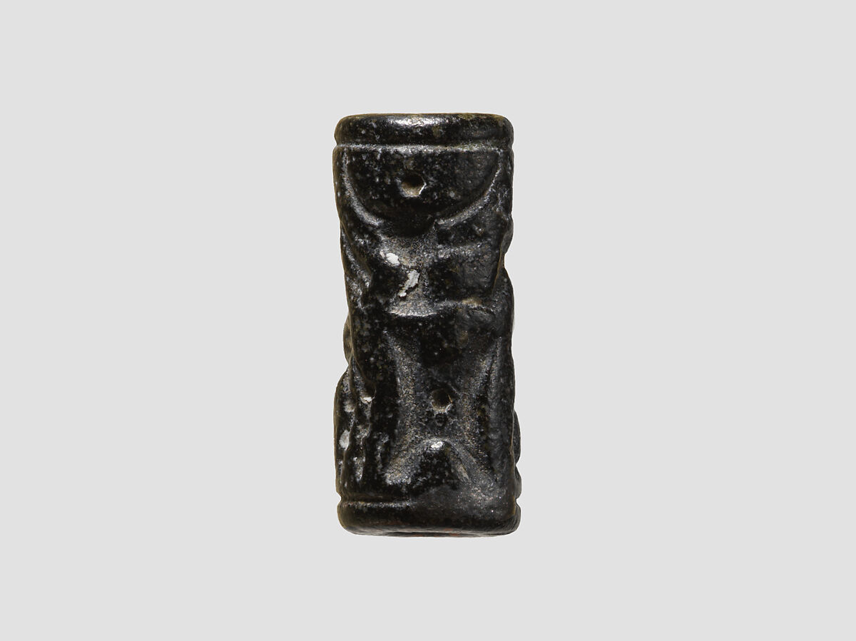 Cylinder seal and modern impression: man grasping an antelope, bull's head over ingot, Black-grey steatite, Cypriot