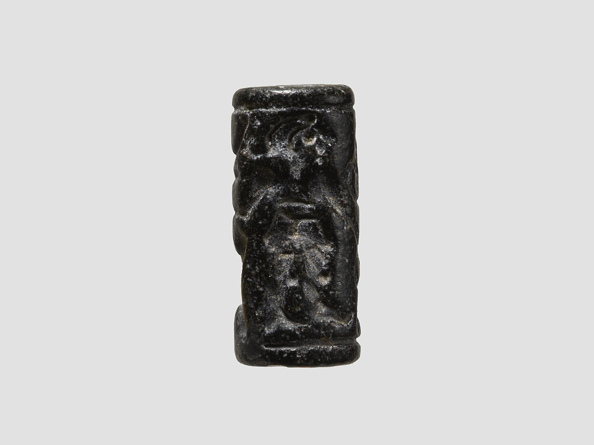 Cylinder seal and modern impression: man grasping an antelope, bull's head over ingot, Black-grey steatite, Cypriot