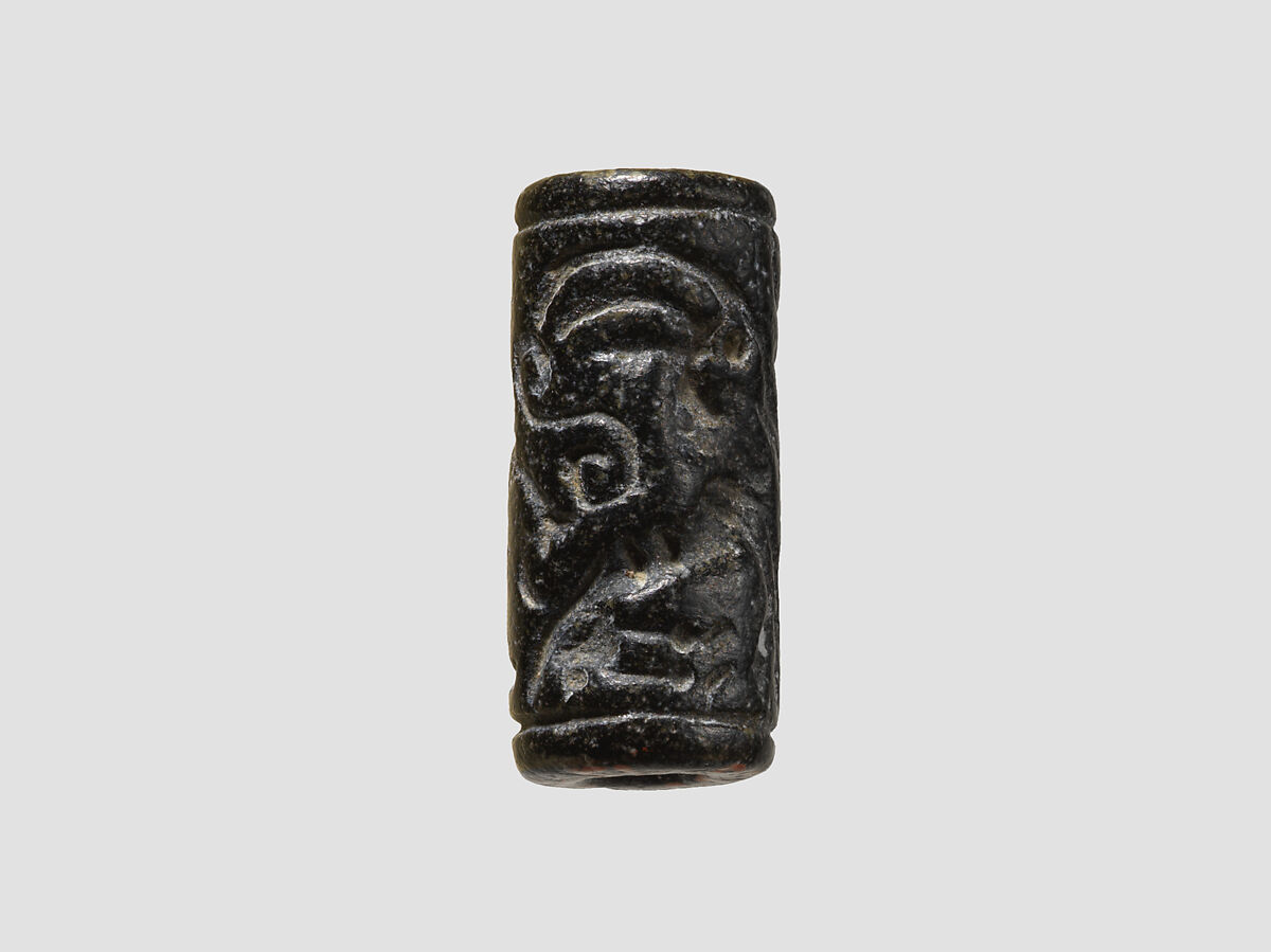 Cylinder seal and modern impression: man grasping an antelope, bull's head over ingot, Black-grey steatite, Cypriot