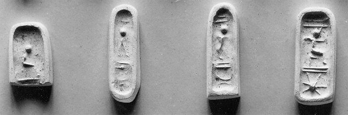 Stamp seal (in the shape of a foot, with loop handle) with deities (?) and anthropomorphic figures, Steatite, black, Phoenician (?) 
