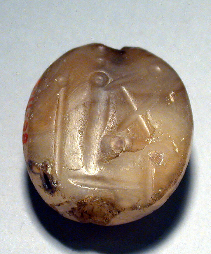 Stamp seal (scaraboid with pointed top) with deity (?), Veined and flawed neutral Chalcedony (Quartz), Assyro-Babylonian 