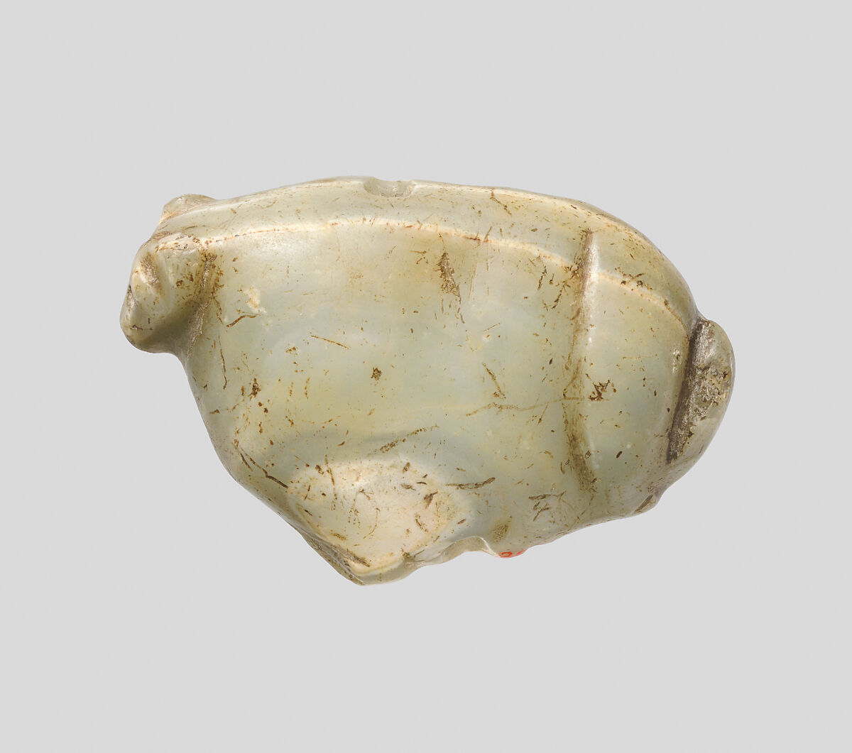 Seal amulet in the form of a recumbent fox, Calcite, green (?) 