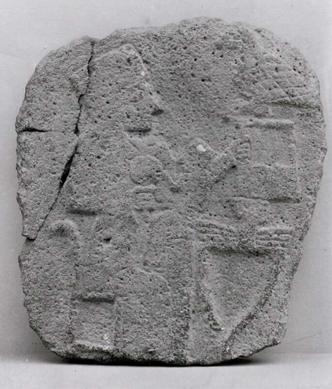 Relief: woman seated at a table, Basalt