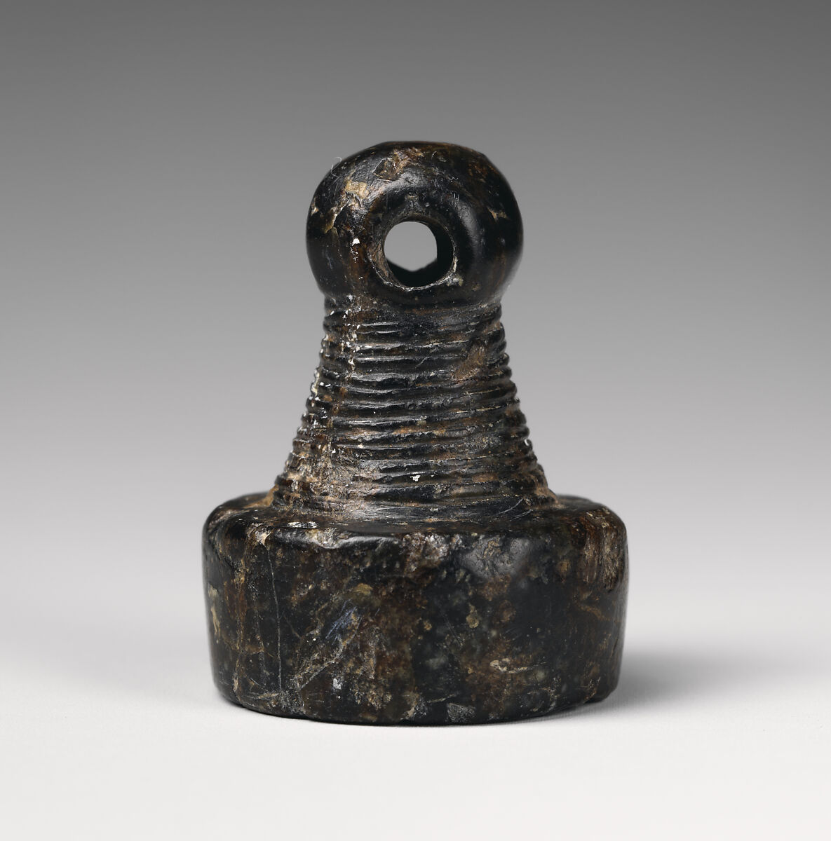 Stamp seal with a knob handle: bird of prey with two horned animals caught in its talons, Black steatite, Old Assyrian Trading Colony