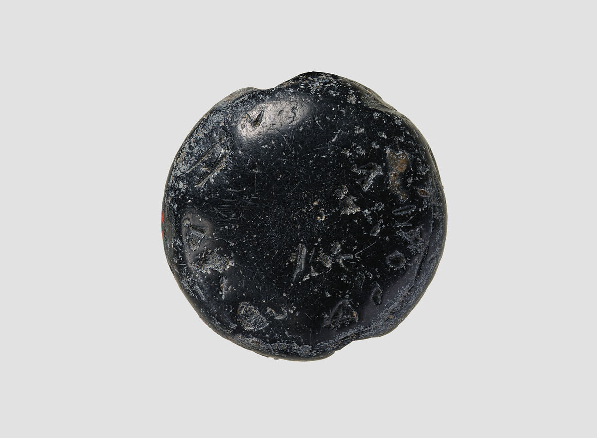 Double convex discoid (bulla) seal engraved on two faces, Black steatite, Hittite