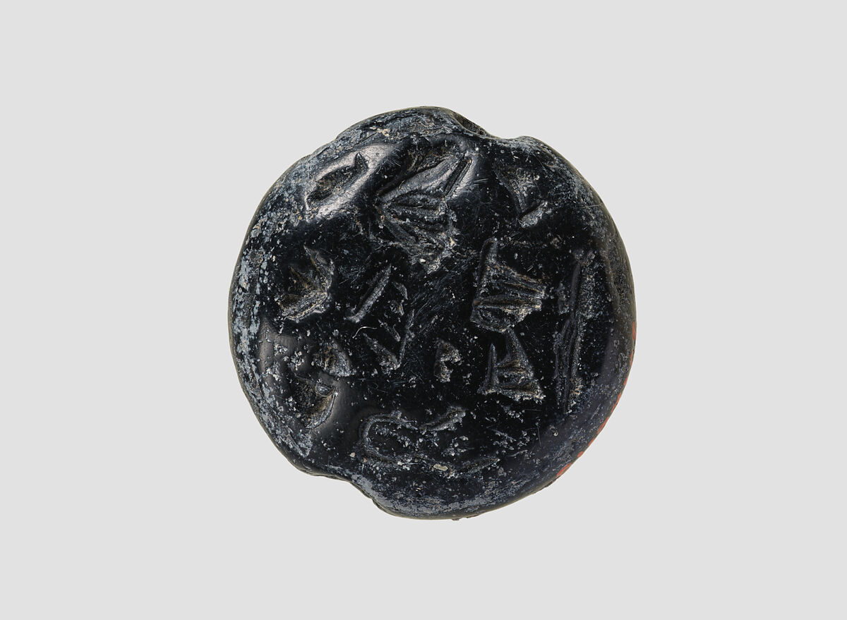 Double convex discoid (bulla) seal engraved on two faces, Black steatite, Hittite