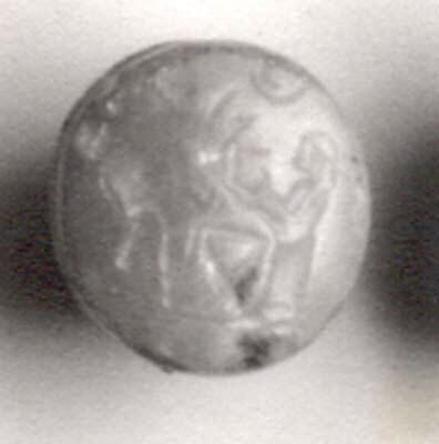 Stamp seal (grooved circular base with loop handle) with cultic scene, Flawed neutral Chalcedony (Quartz), Assyro-Babylonian 