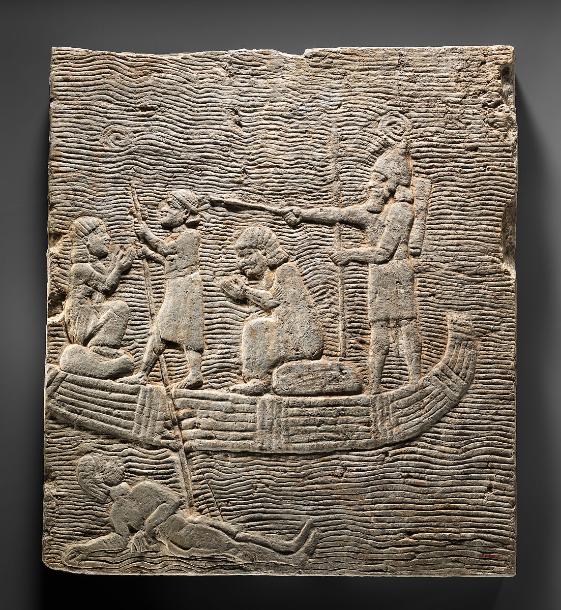 Relief fragment: Assyrian soldier conducting captives across the water