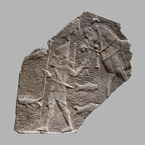 Relief fragment: cavalryman leading his horse beside a stream