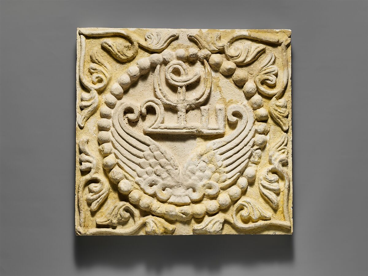 Wall panel with wings and a Pahlavi device encircled by pearls, Stucco, Sasanian 