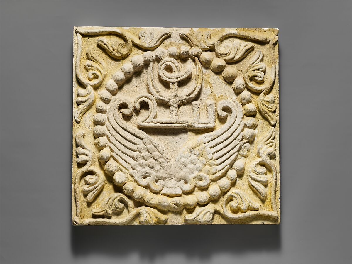 Wall panel with wings and a Pahlavi device encircled by pearls, Stucco, Sasanian