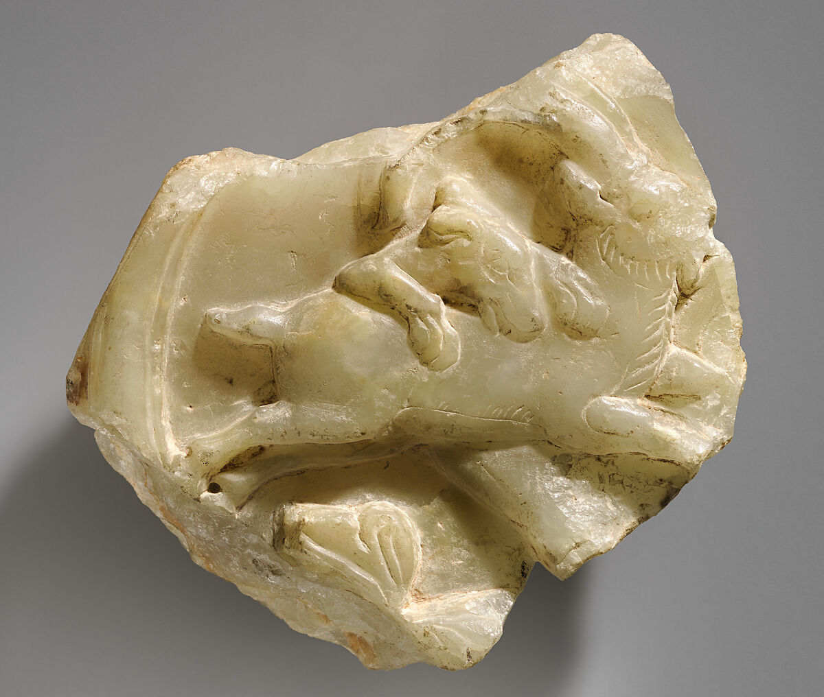 Relief fragment with dog attacking a running ibex, Alabaster, Sasanian 