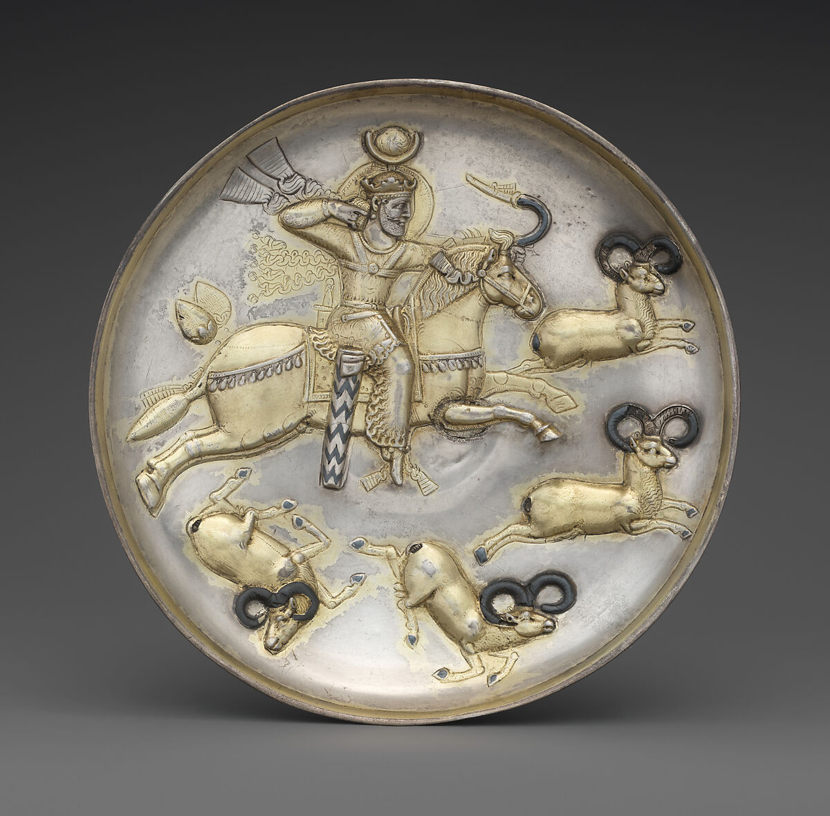 Plate with king hunting rams, Silver, mercury gilding, niello inlay, Sasanian