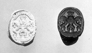 Scarab seal with Bes dominating two lions below a winged sun disc, Jasper, green 