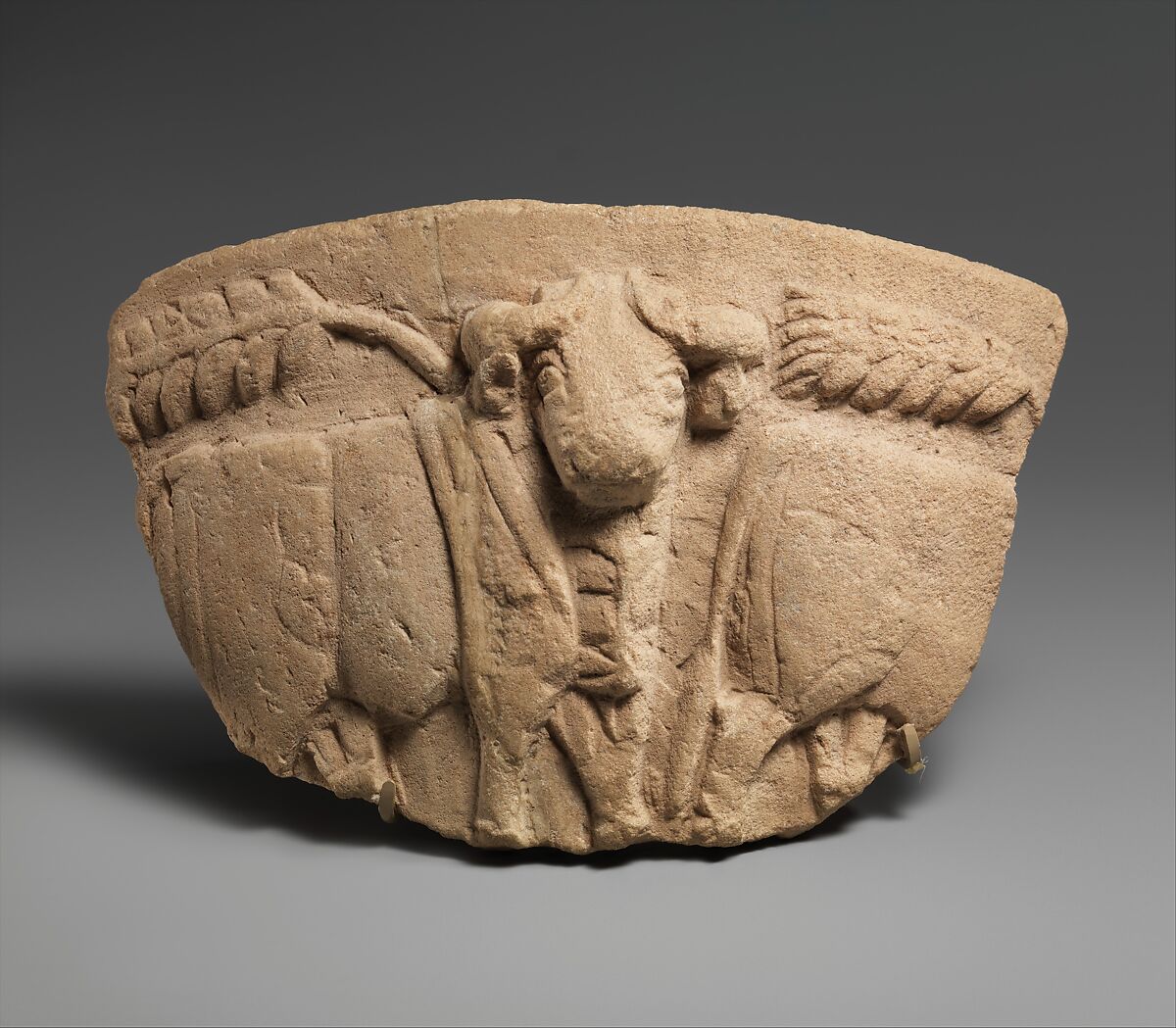 Fragment of a vessel with wheat stalks and a procession of bulls in relief, Limestone 