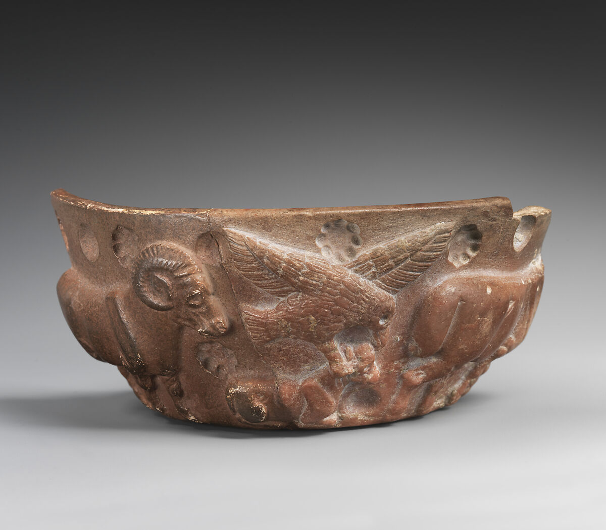 Fragment of a vessel with a bird of prey attacking a crouched animal in relief, Limestone 