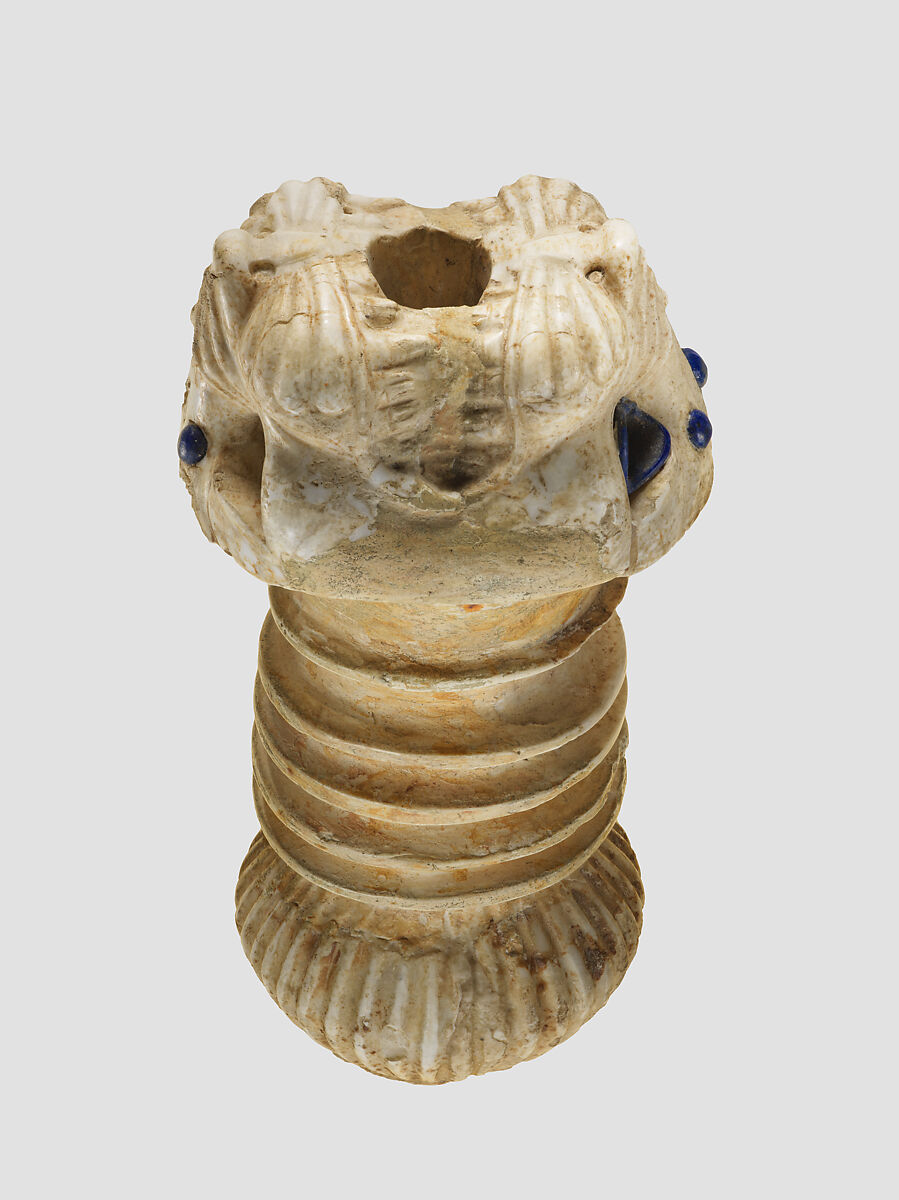 Ornament with heads of roaring lions, possibly the terminal of a sword or dagger hilt, Limestone, lapis lazuli, faience inlay, Assyrian