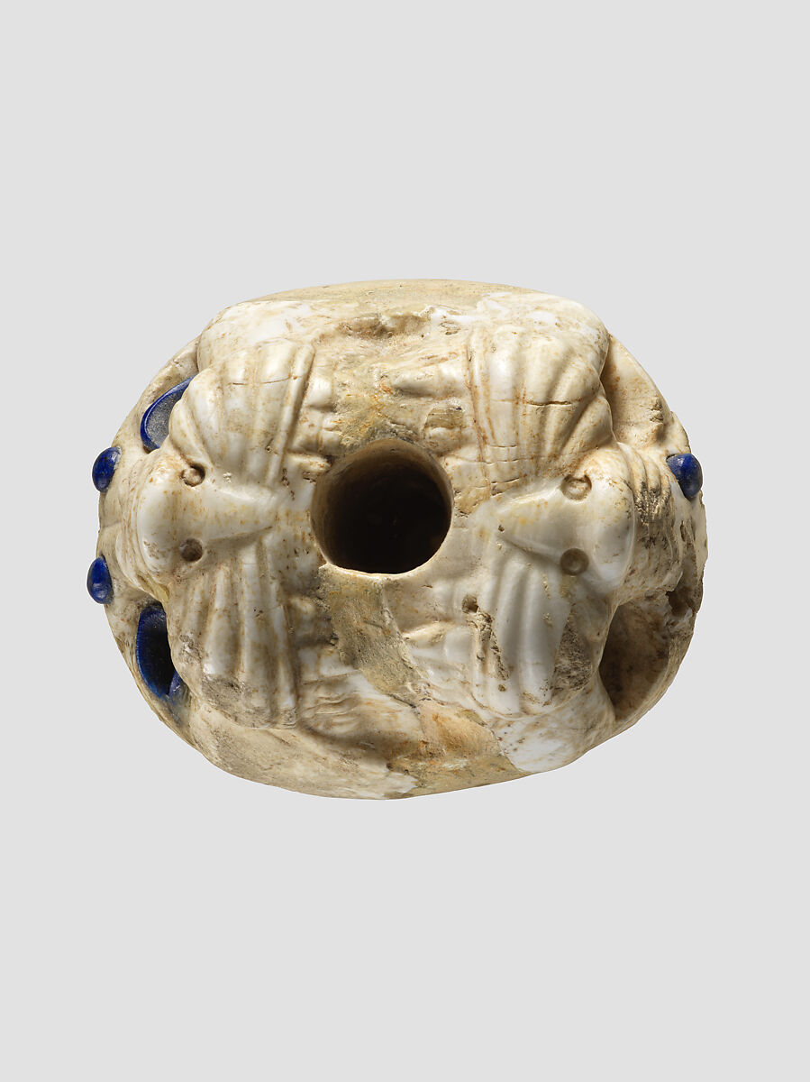 Ornament with heads of roaring lions, possibly the terminal of a sword or dagger hilt, Limestone, lapis lazuli, faience inlay, Assyrian
