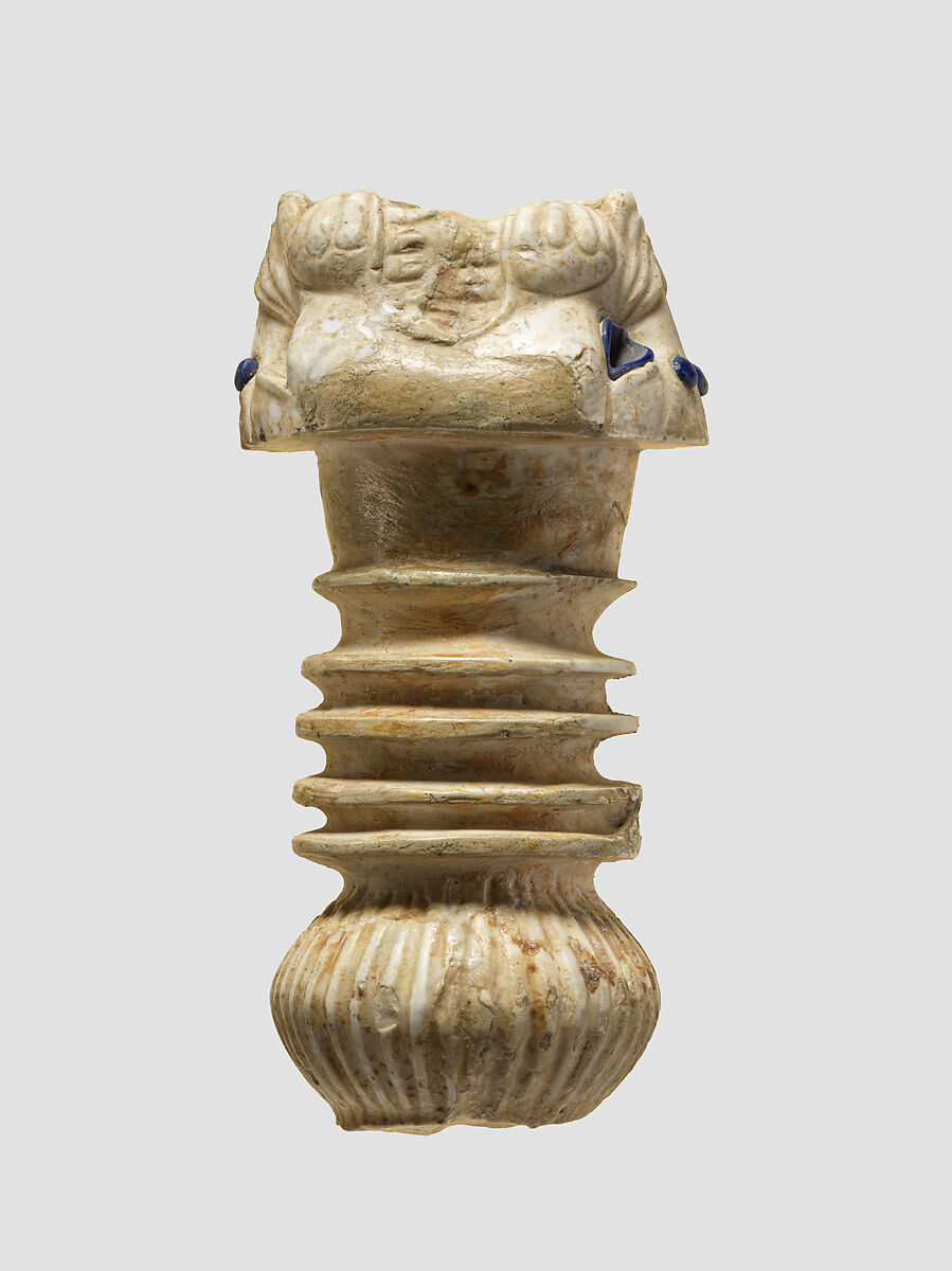 Ornament with heads of roaring lions, possibly the terminal of a sword or dagger hilt, Limestone, lapis lazuli, faience inlay, Assyrian