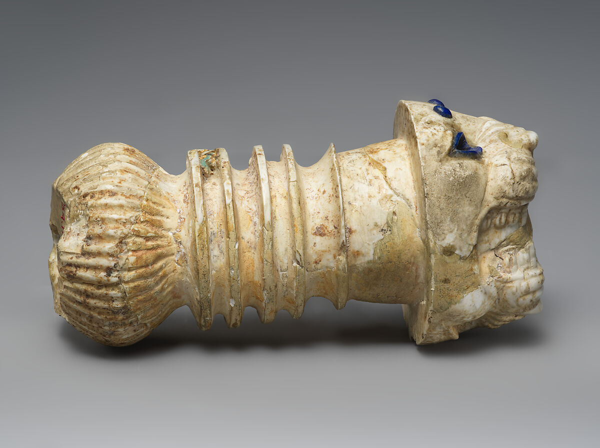 Ornament with heads of roaring lions, possibly the terminal of a sword or dagger hilt, Limestone, lapis lazuli, faience inlay, Assyrian