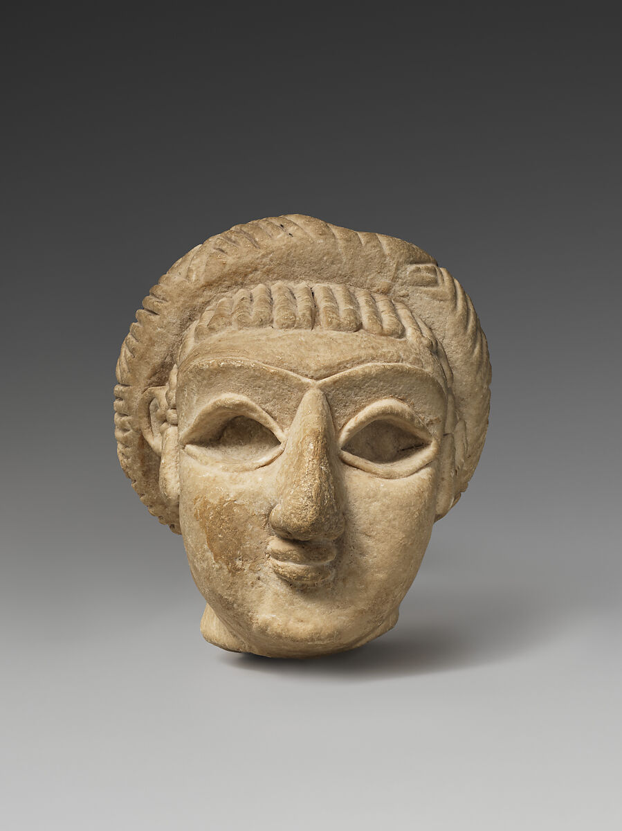 Female head with elaborate hairstyle, Limestone 