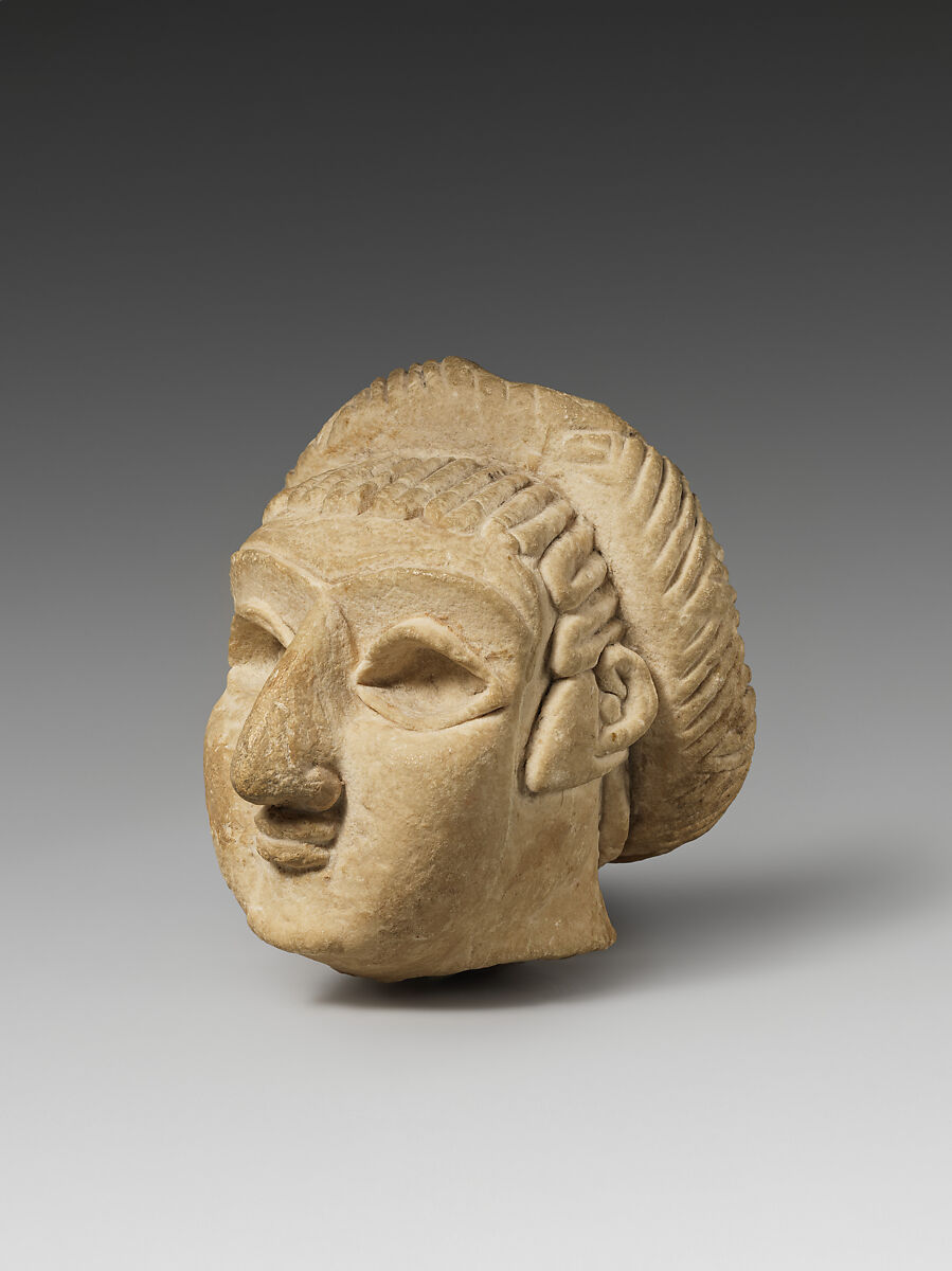Female head with elaborate hairstyle, Limestone