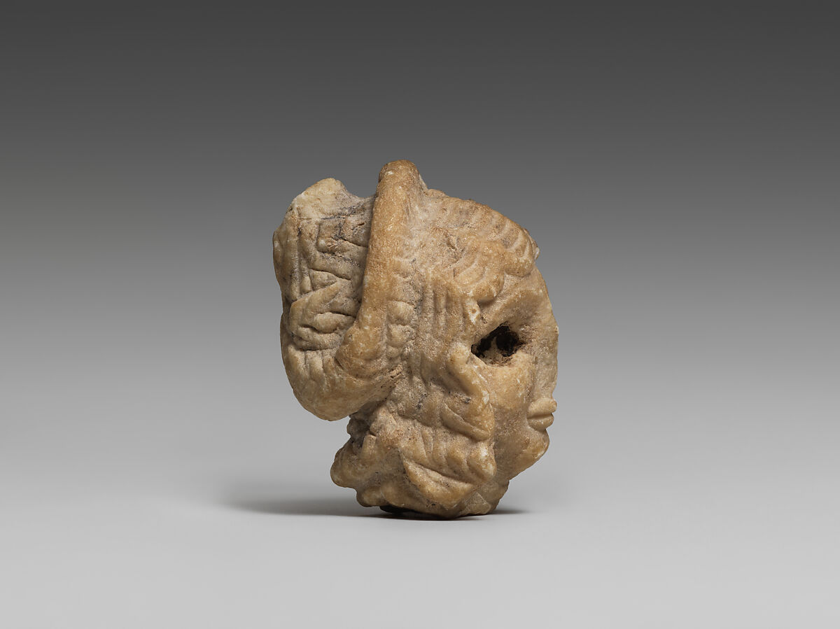 Female head with elaborate hairstyle, Gypsum alabaster