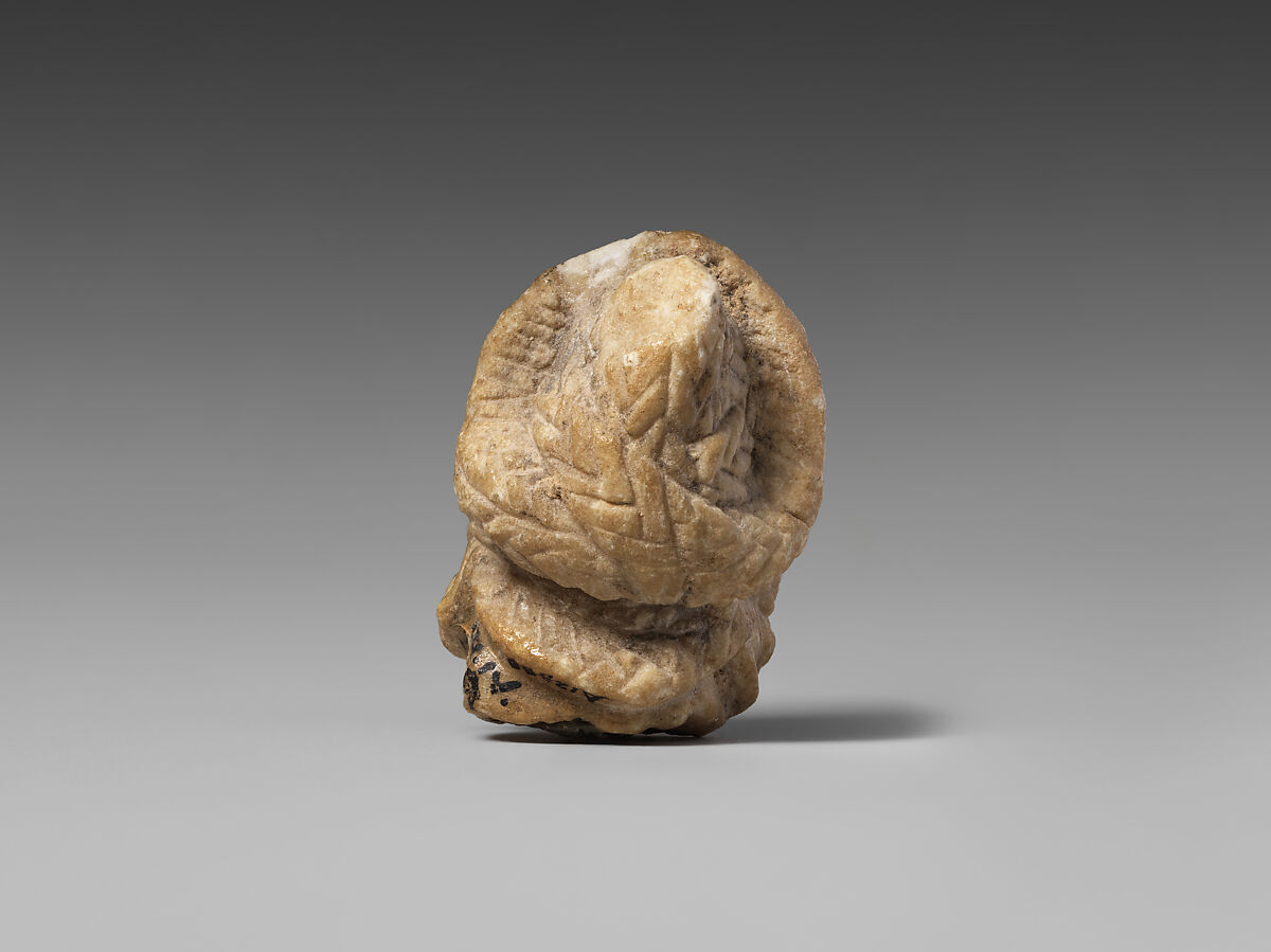 Female head with elaborate hairstyle, Gypsum alabaster