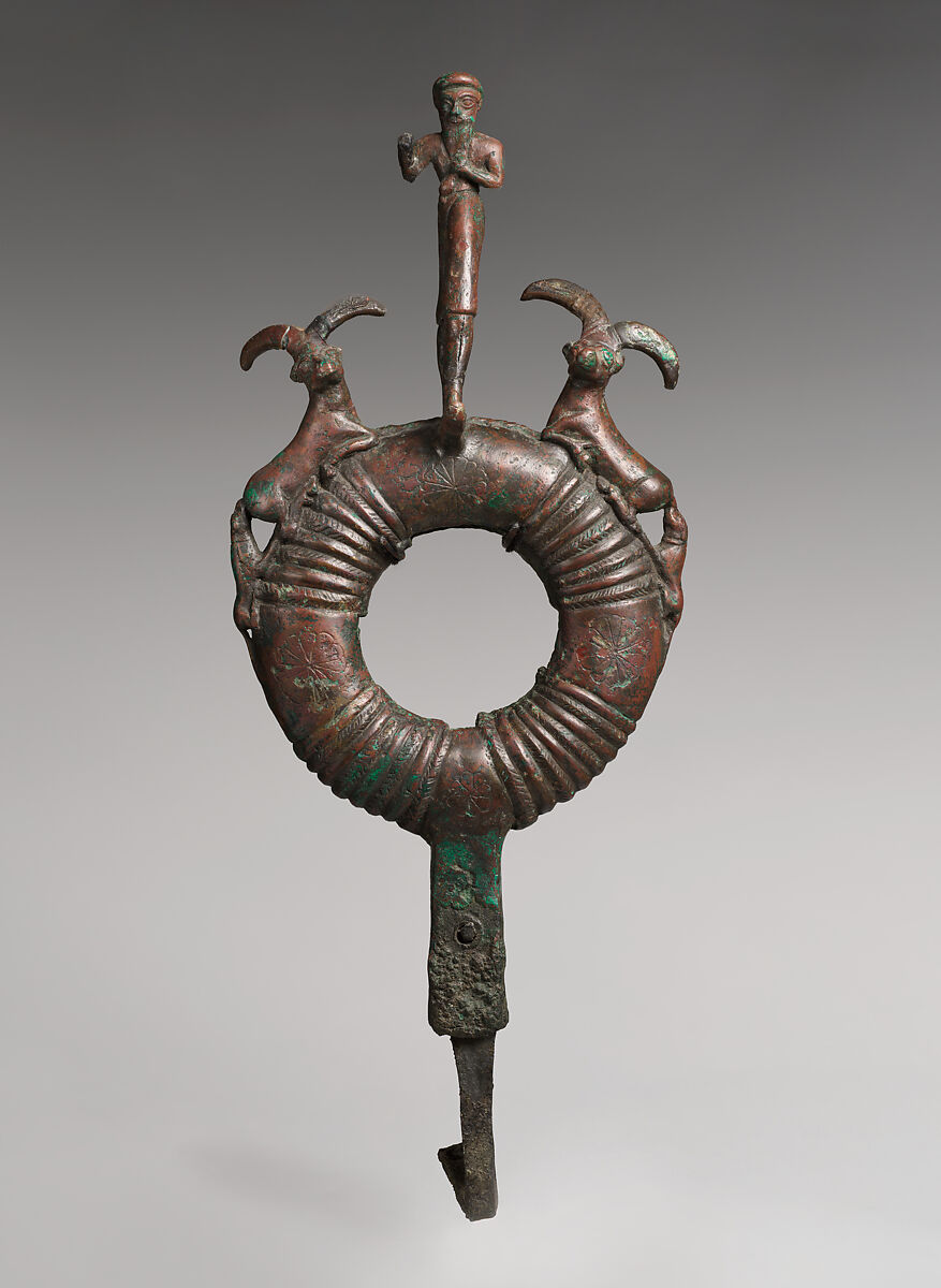 Top of standard with male figure and flanking ibexes attacked by dogs, Bronze, Elamite