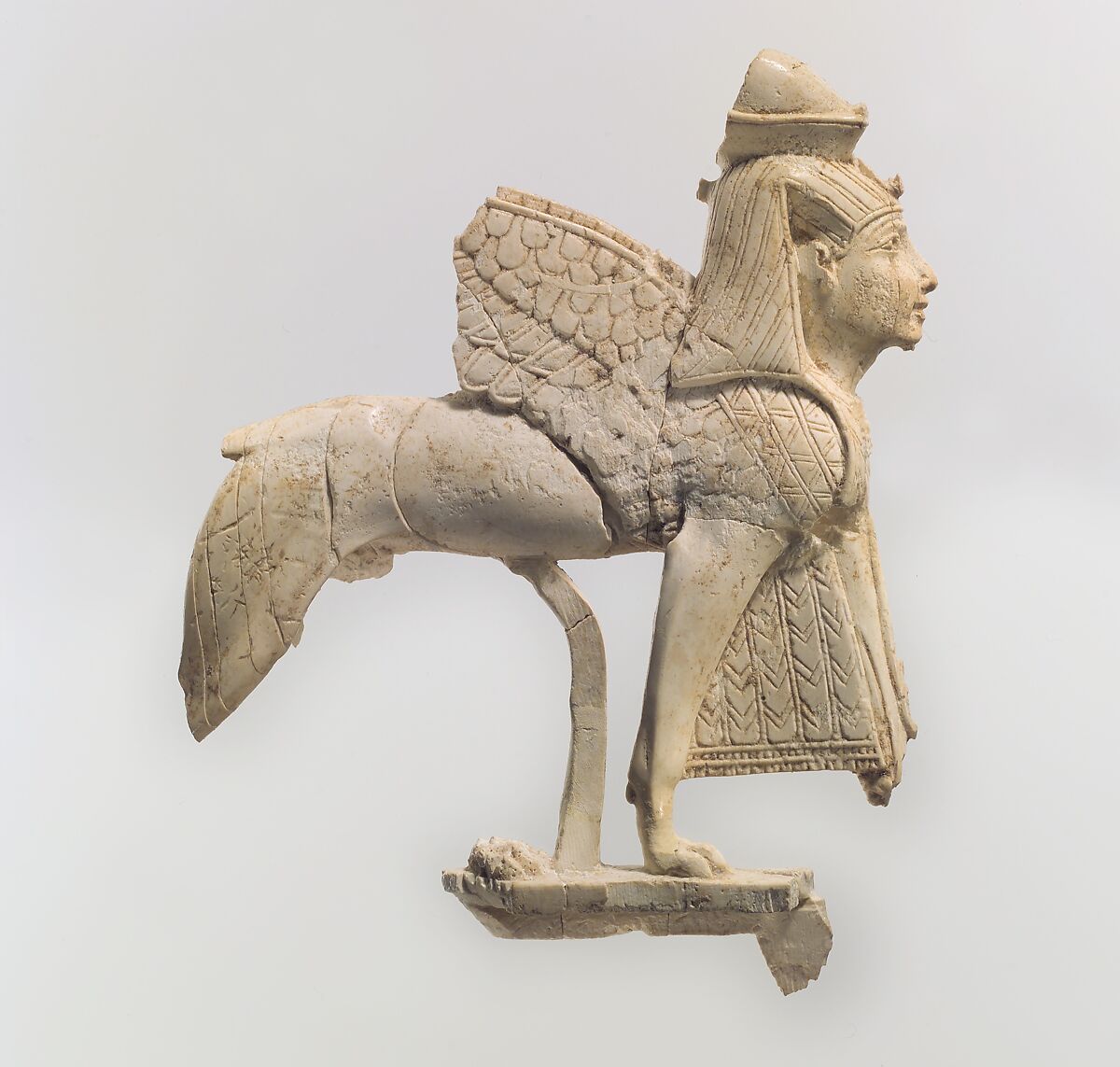 Openwork furniture plaque with a striding sphinx, Ivory, Assyrian 