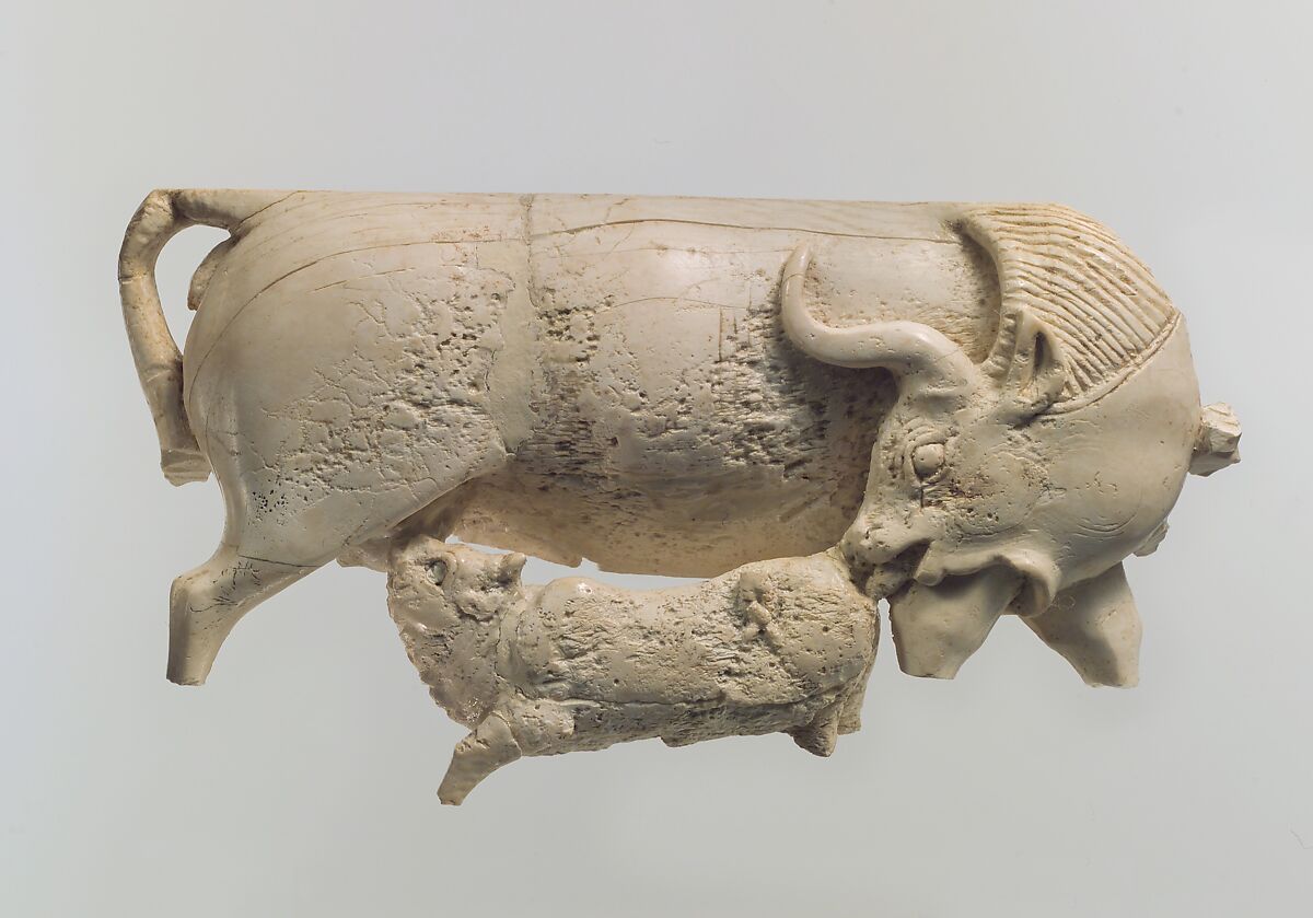 Openwork furniture plaque showing a cow suckling a calf, Ivory, Assyrian 