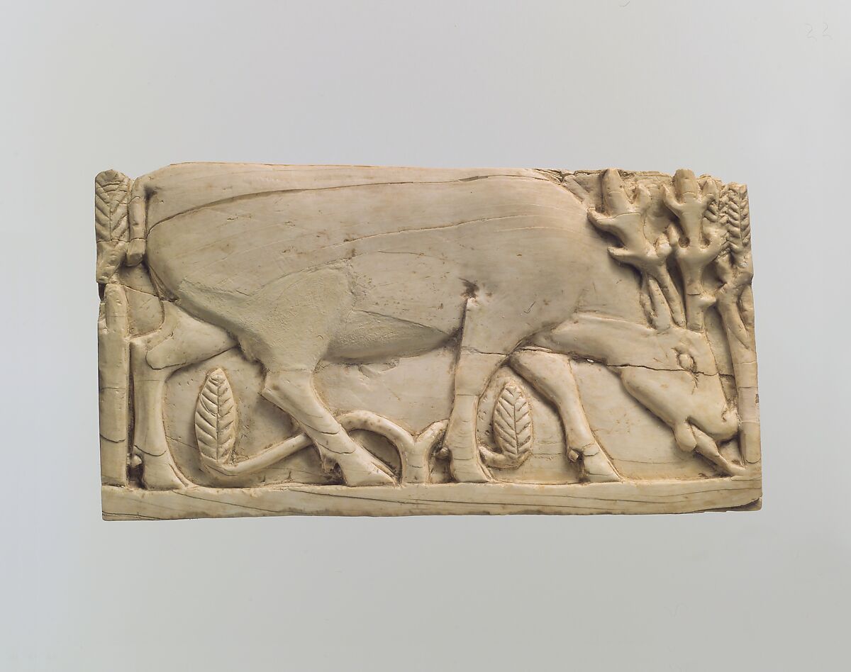 Furniture plaque carved in relief with a stag grazing among plants, Ivory, Assyrian 