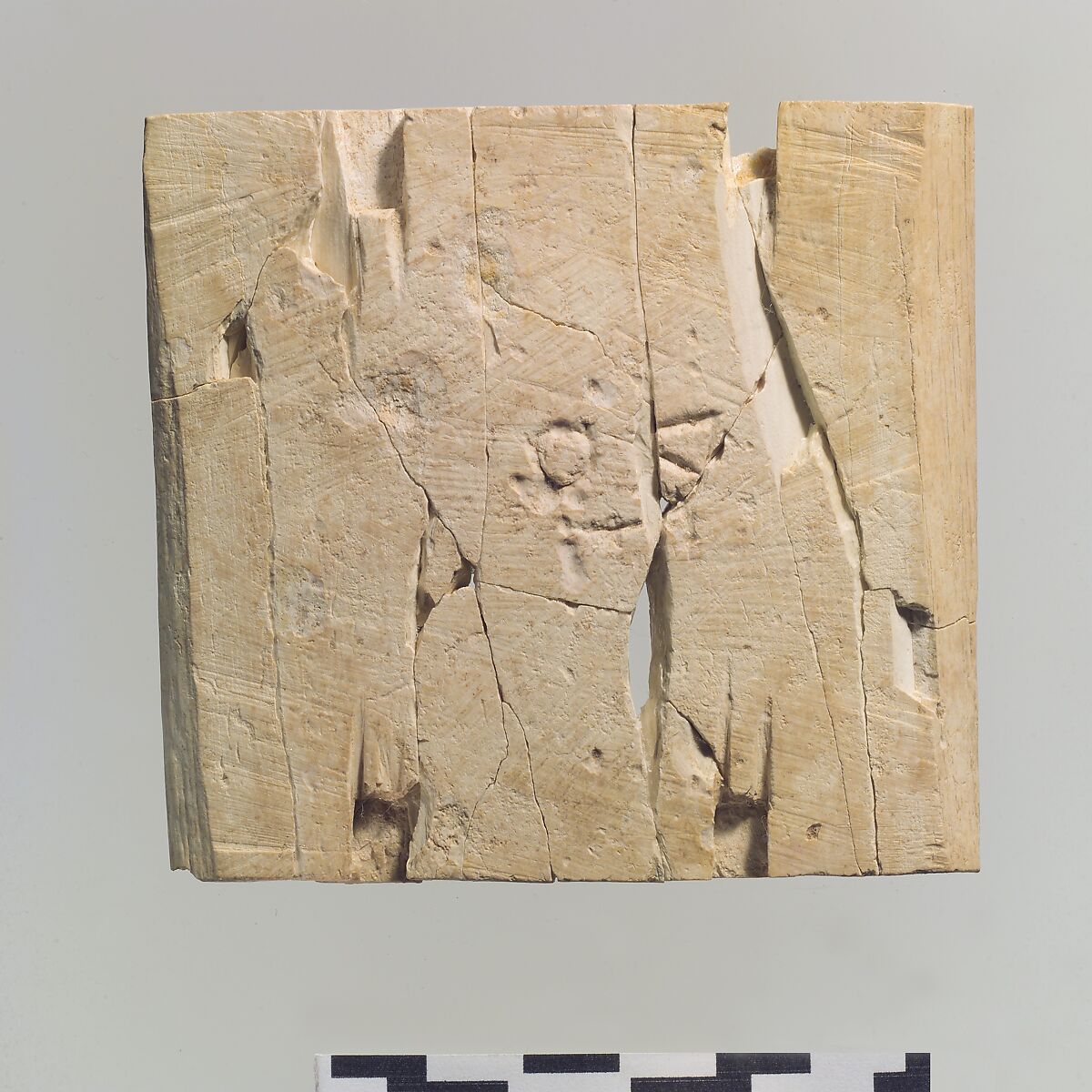 Furniture plaque carved in relief showing two winged, male figures flanking an infant on a lotus flower, Ivory, Assyrian