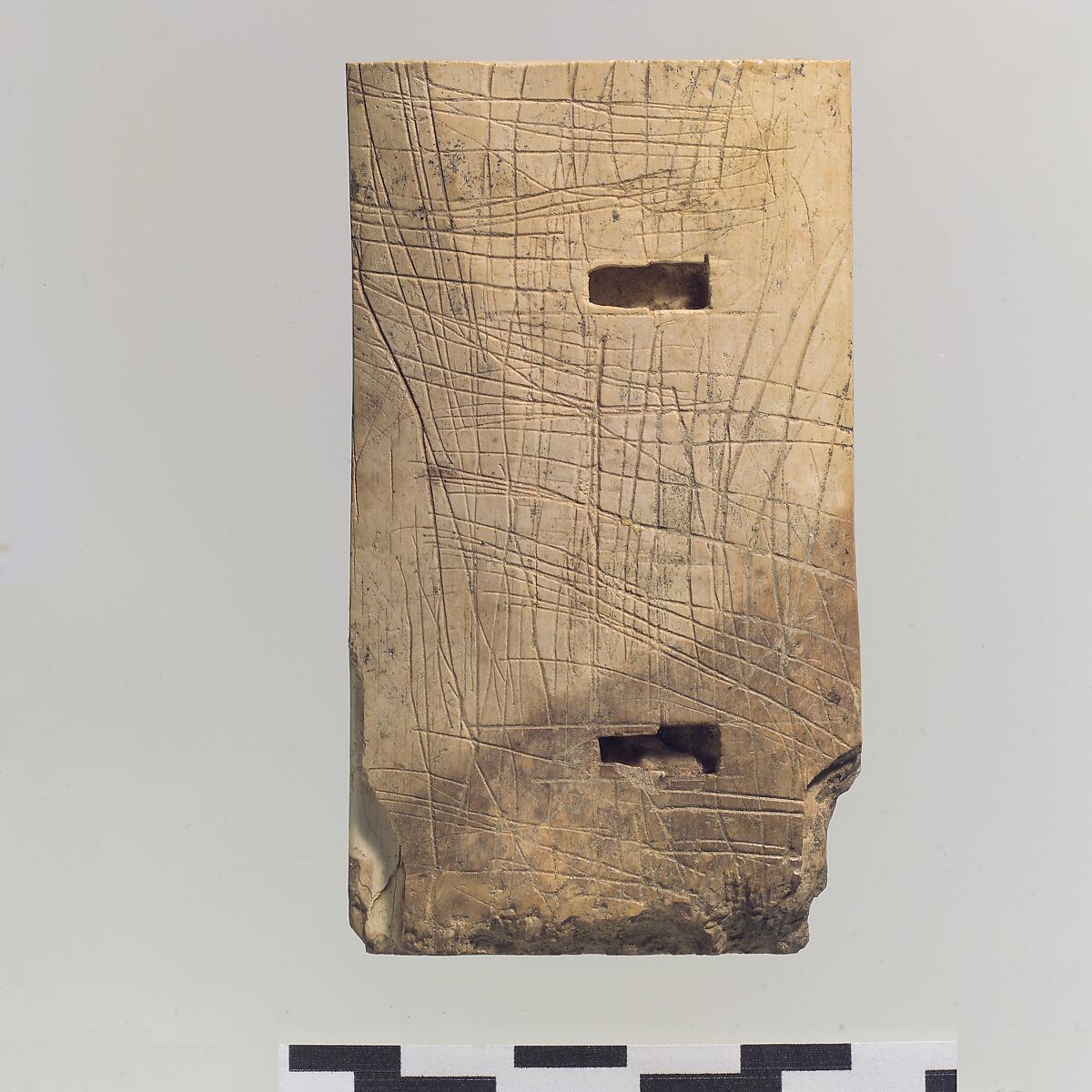 Furniture plaque carved in relief with a winged female figure and a “sacred tree”, Ivory, gold, Assyrian