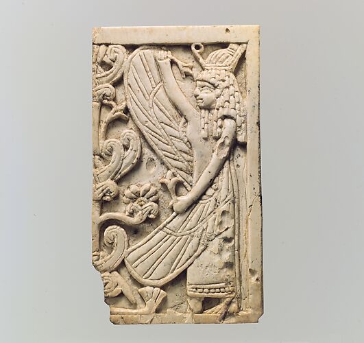 Furniture plaque carved in relief with a winged female figure and a “sacred tree”