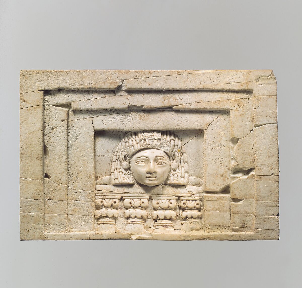Furniture plaque carved in relief with a “woman at the window”, Ivory, Assyrian 