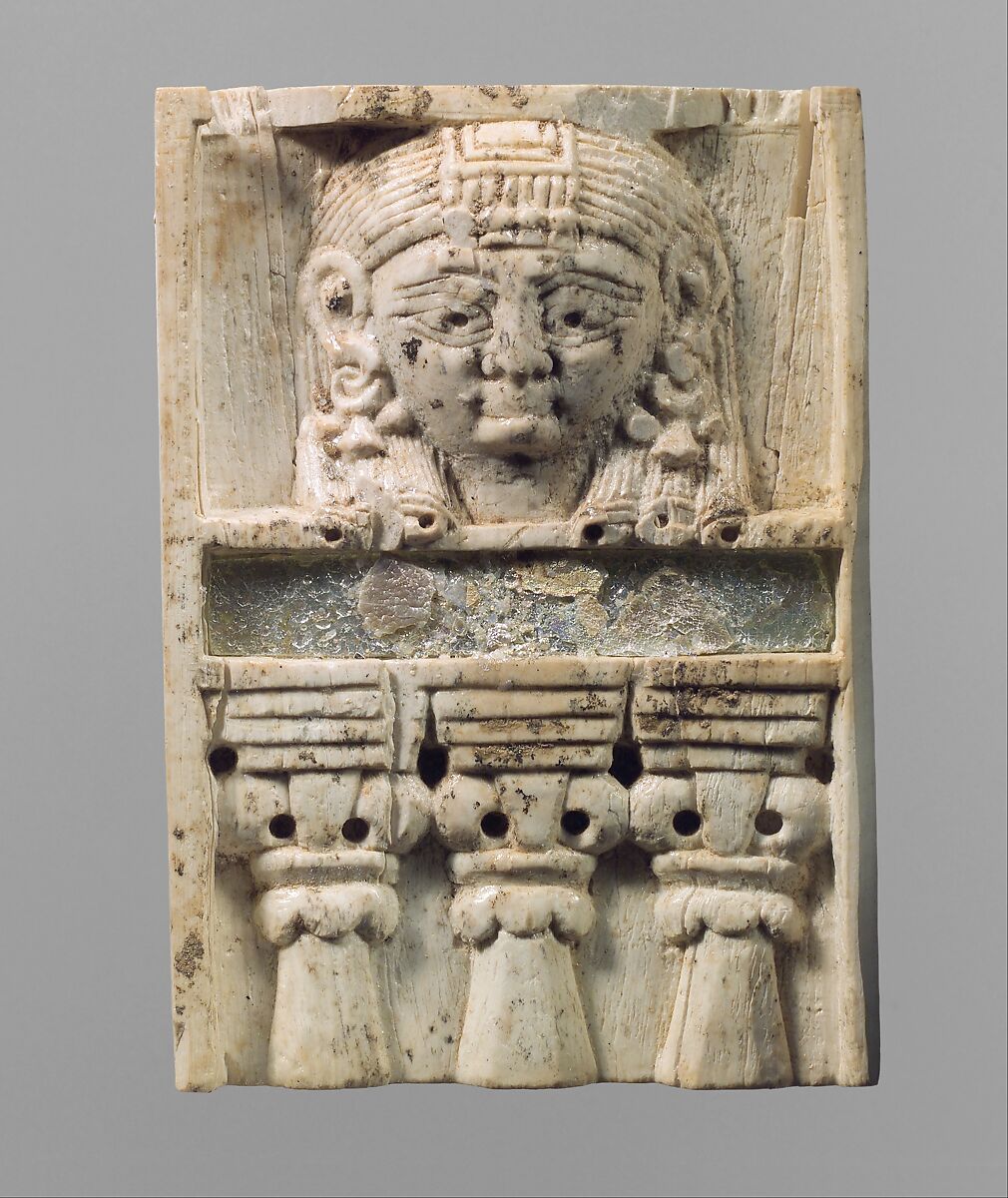 Furniture plaque carved in relief with a “woman at the window”, Ivory, glass, Assyrian 