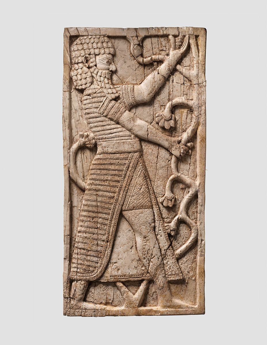 Furniture plaque carved in relief with striding man, Ivory, Assyrian 