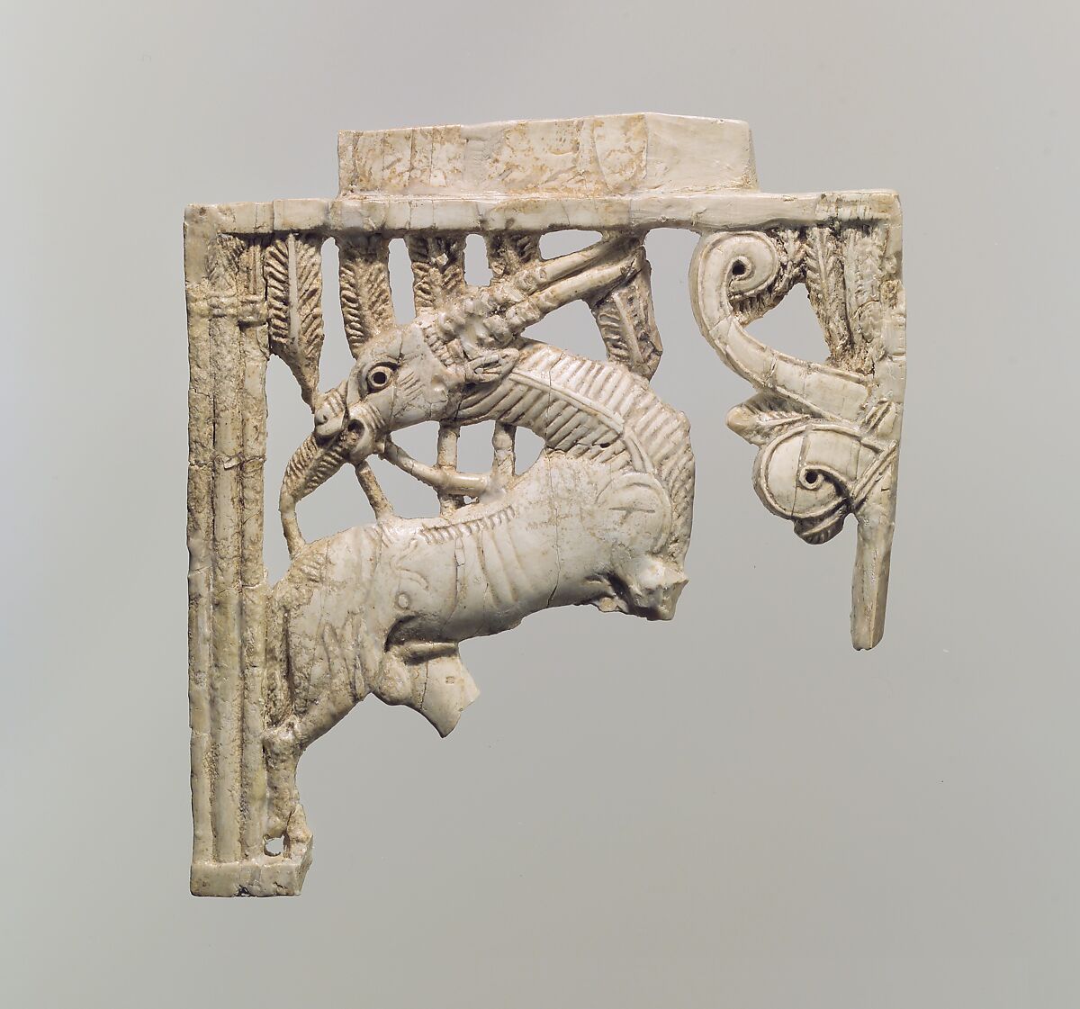 Openwork furniture plaque with a grazing oryx in a forest of fronds, Ivory, Assyrian 
