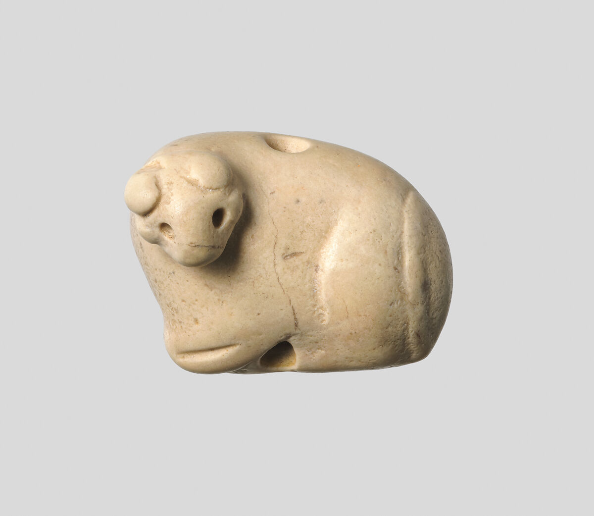Seal amulet in the form of a recumbent bovid, Stone, cream colored 