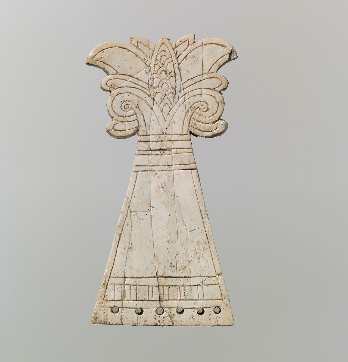 Incised horse frontlet carved into the shape of a flowering, volute palmette tree, Ivory, Assyrian 