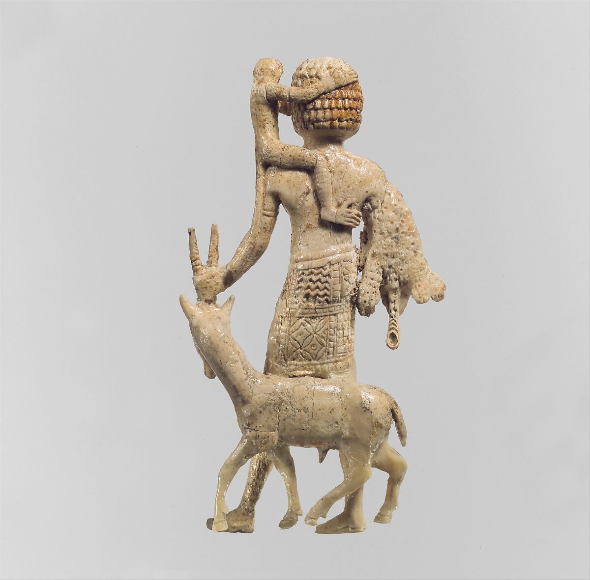 Figure of a man with an oryx, a monkey, and a leopard skin, Ivory, Assyrian