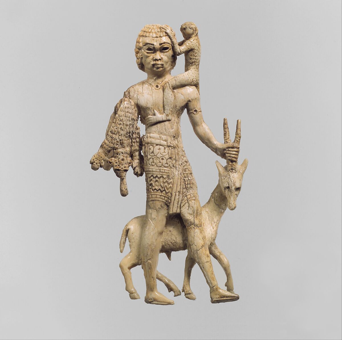 Figure of a man with an oryx, a monkey, and a leopard skin, Ivory, Assyrian 