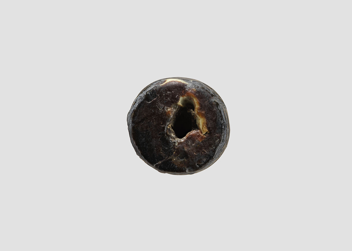 Cylinder seal (with pin preserved) with animal-monster contest scene, Black Steatite, with copper/bronze pin, Assyrian